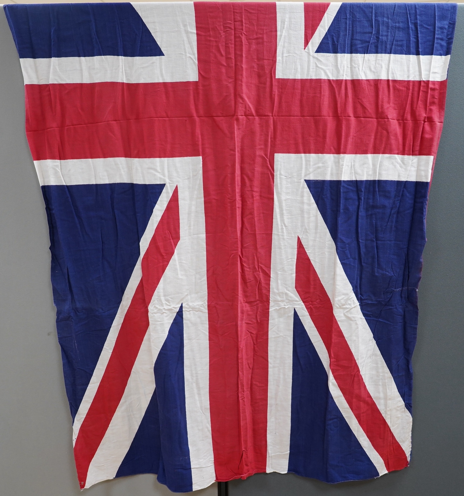 Four early to mid 20th century flags including; two Union Jack flags, a British naval ensign and an American confederate flag, 62 x 86cm. Condition - poor to fair